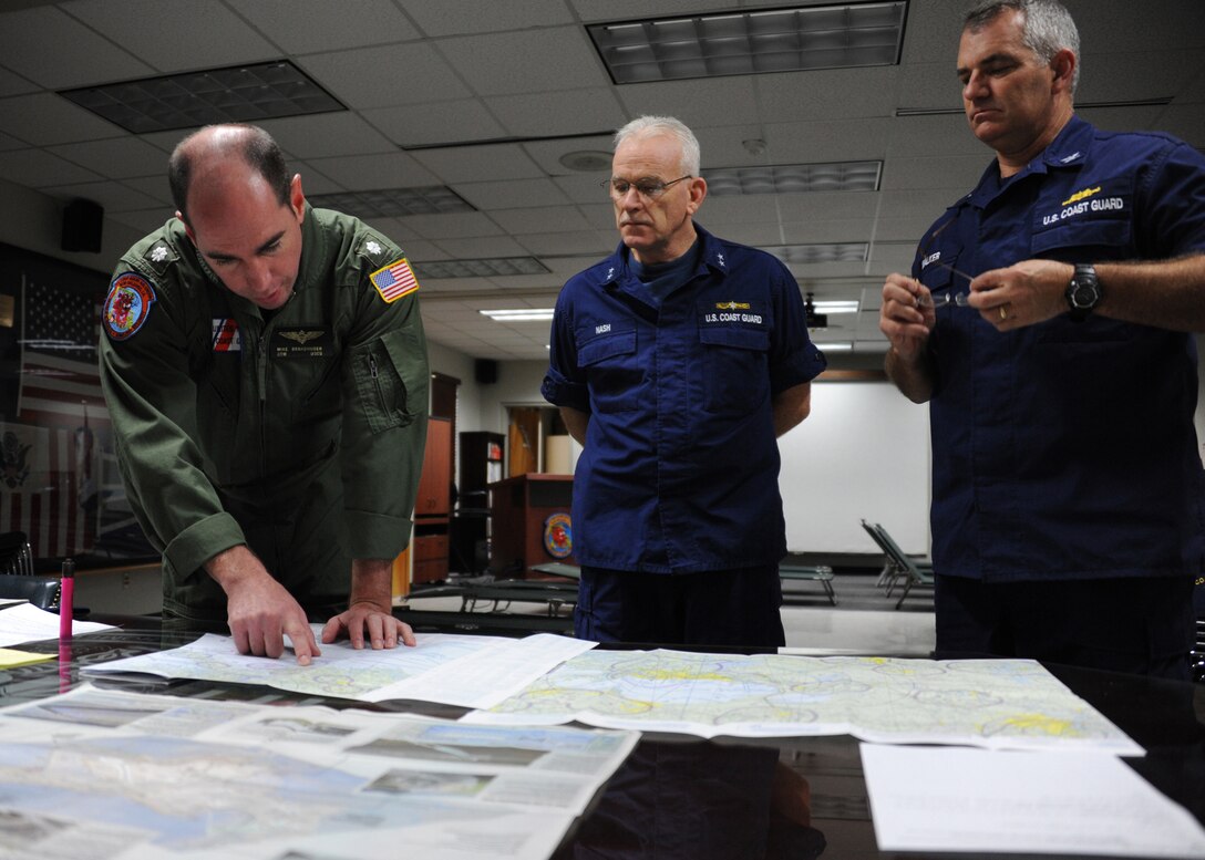 Coast Guard Cmdr. Michael Brandhuber, left, delivers a pre-flight brief to Rear Adm. Roy Nash, commander of the Eighth Coast Guard District, and Capt. Samuel Walker, response chief for the Eighth Coast Guard District, while preparing for Hurricane Isaac recovery operations in New Orleans, Sept. 1, 2012.  Brandhuber is the commanding officer of Coast Guard Air Station New Orleans.