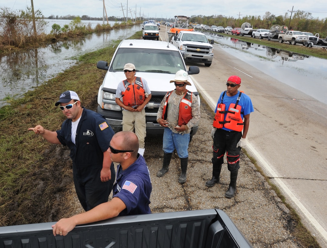 Coast Guard Petty Officer 3rd Class Matthew Roberts discusses strategies with Richard Ford, an Environmental Safety & Health crewmember, before setting out on pollution assessment missions following Hurricane Isaac near Myrtle Grove, La., Sept. 2, 2012. 