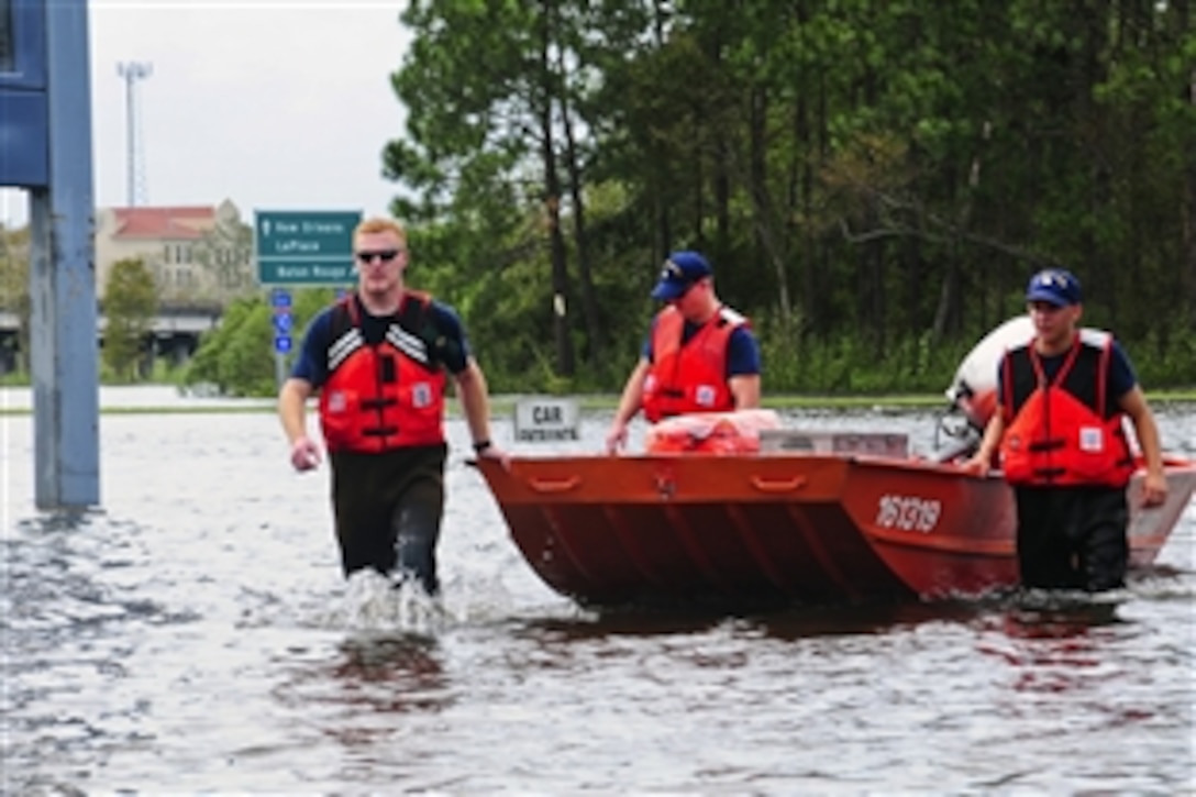 Members of a Coast Guard Disaster Assistance Response Team return from medically evacuating a stranded trucker near the Highway 55 underpass in LaPlace, La., Aug. 31, 2012. The team, along with other members of the U.S. Coast Guard, were in the area to help with recovery operations following Hurricane Isaac.
