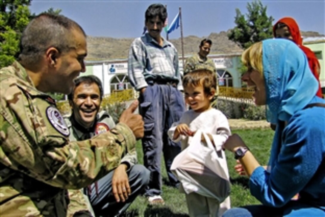 International Security Assistance Force members play with an Afghan child at the Physiotherapy and Rehabilitation Support for Afghanistan Orphanage in Kabul, Afghanistan, Aug. 31, 2012. The service members were on hand to pass out school supplies and candy to children at the orphanage.