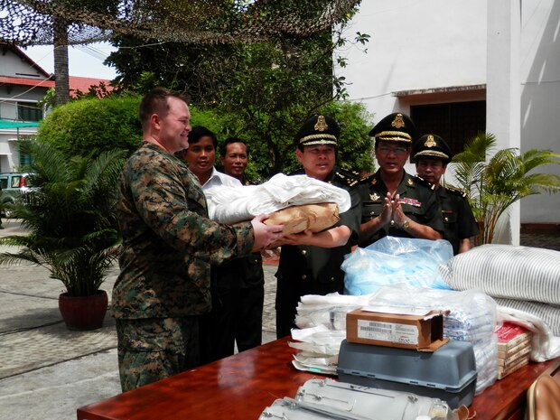 Lt. James Armitage, left, showcases medical equipment to Royal Cambodian Armed Forces Lt. Gen. Ly Sovann at Phnom Penh, Cambodia, Aug. 17 during the Cambodia Medical Exercise 12-2. The supplies were delivered during a weeklong medical exchange operation known as Cambodia MEDEX 12.2.Armitage is with 3rd Medical Battalion, Combat Logistics Regiment 35, 3rd Marine Logistics Group. Sovann Hospital Director