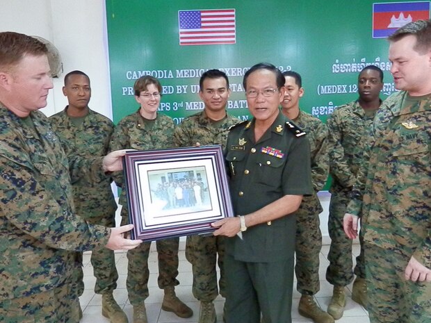 Senior Enlisted Leader HMC Chris Guckeyson presents Brig. Gen. Keo Davuth with a commemorative photo at Phnom Penh, Cambodia Aug. 24. The photo was presented on behalf of 3rd Medical Battalion, Combat Logistics Regiment 35, 3rd Marine Logistics Group at the conclusion of Cambodia  Medical Exercise 12.2.