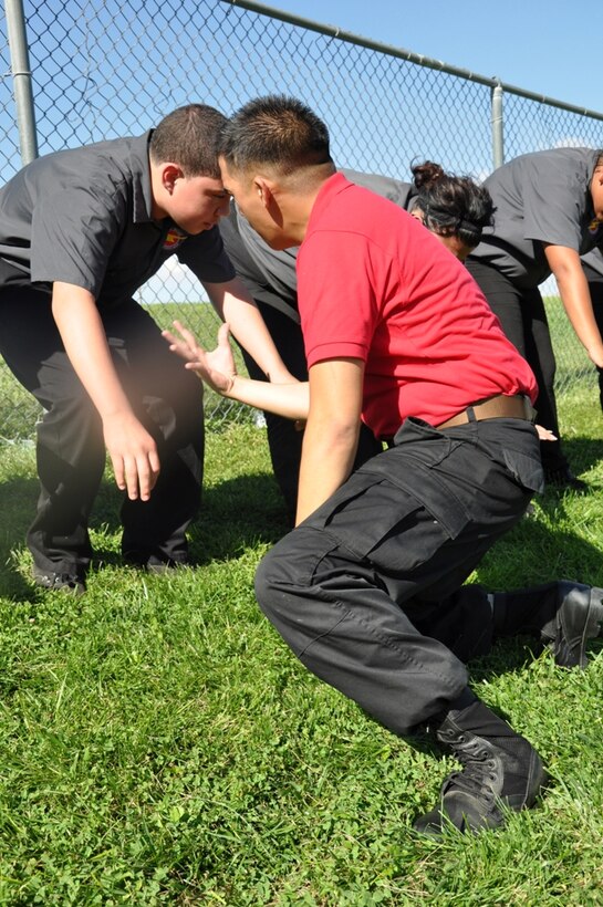 Cpl. Van Truong, an adjutant clerk with Marine Corps Logistics Base Barstow Calif., motivates SHOCK students to push through the pain Aug, 24. The SHOCK program helps misguided teens of Apple Valley Calif. become upstanding citizens. Photo by: Pfc. Norman Eckles