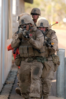 Marines with Company F prepare to clear a building during a bilateral assault at the urban operations training facility at Mount Bundy Training Area Sept. 5.