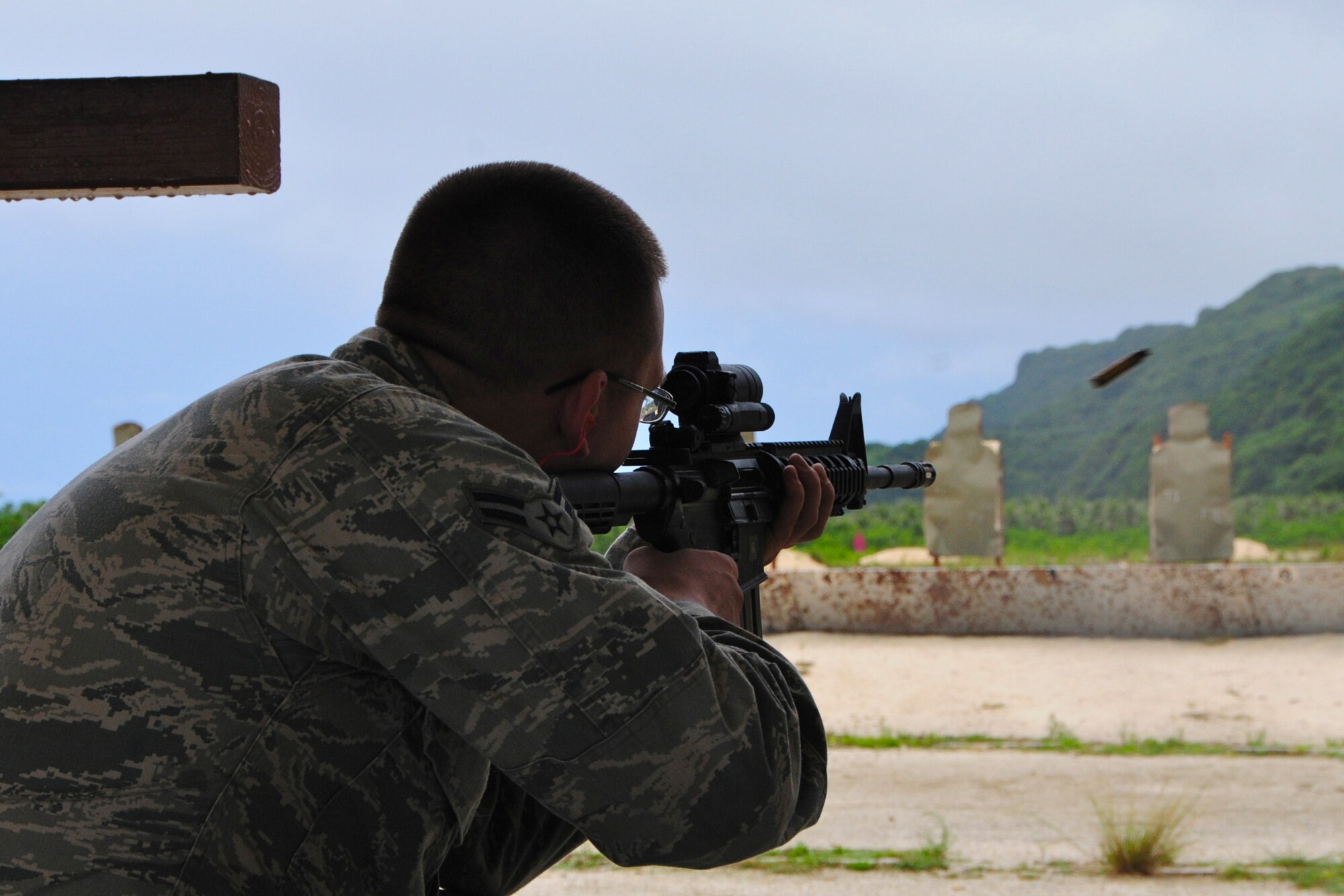 ANDERSEN AIR FORCE BASE, Guam -- Airman 1st Class Dalton Ridder, 36th Civil Engineer Squadron pavement and construction equipment apprentice, fires his weapon during the qualification portion of combat arms training here Aug. 28. The Air Force recently implemented a new weapons qualification course that contains both the original basic firing positions and a new section that includes advanced tactical movements. (U.S. Air Force photo by Airman 1st Class Marianique Santos/Released)