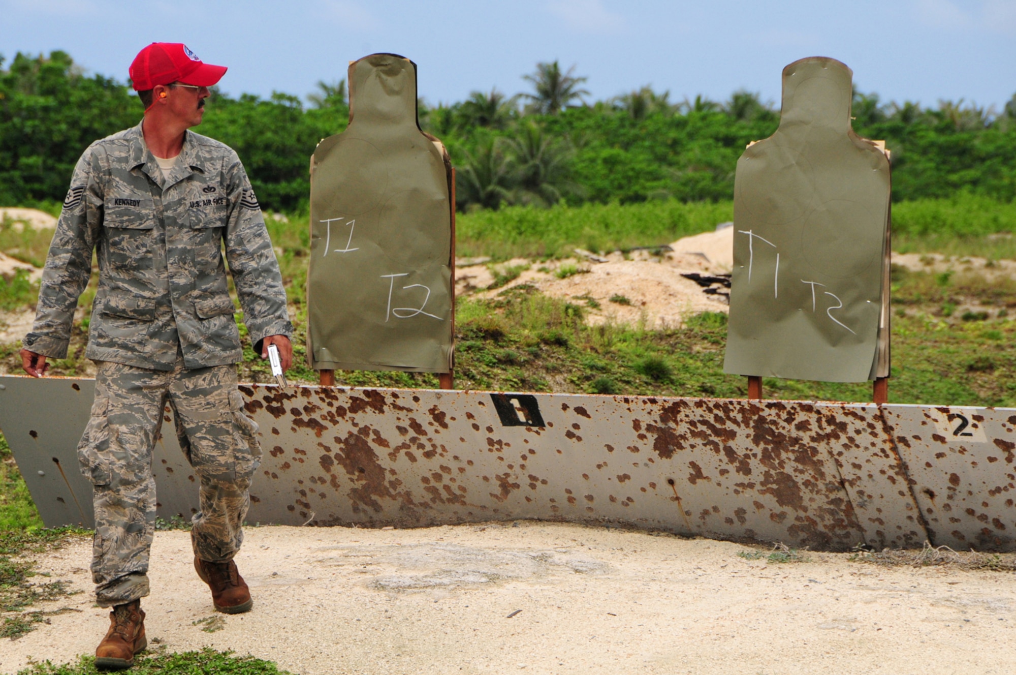 ANDERSEN AIR FORCE BASE, Guam -- Tech. Sgt. Joel Kennedy, 554th RED HORSE Squadron explosive demolition team noncommissioned officer in charge, double checks his targets to make sure they are marked correctly at the Combat Arms Training and Maintenance range here Aug.  28. The Air Force recently implemented a new weapons qualification course that contains both the original basic firing positions and a new section that includes advanced tactical movements. (U.S. Air Force photo by Airman 1st Class Marianique Santos/Released)