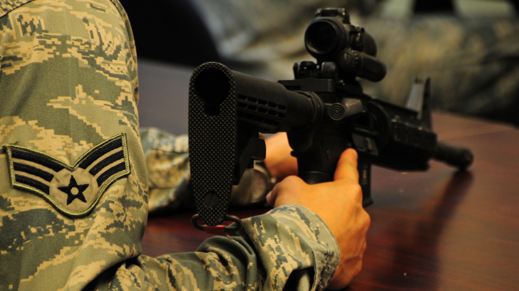 ANDERSEN AIR FORCE BASE, Guam -- Airmen from the 36th Wing are issued weapons during the classroom portion of combat arms training here Aug. 28. During the classroom session, the Airmen get familiarized with their weapon and learn how to keep their weapon in good working order. (U.S. Air Force photo by Airman 1st Class Marianique Santos/Released)