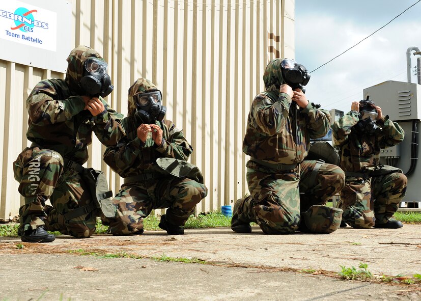 Korean civilians put on their gas masks and protective gear during training on Kunsan Air Base, Republic of Korea, Sept. 5, 2012. Civilian personnel are required to complete this training annually to ensure the base has full mission capabilities during a chemical or biological attack. (U.S. Air Force Photo/Staff Sgt. Jonathan Fowler)