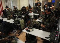 Korean civilian personnel put on chemical protective equipment during a training session on Kunsan Air Base, Republic of Korea, Sept. 5, 2012. Civilian personnel are required to complete this training to ensure the base has full mission capabilities during a chemical or biological attack. (U.S. Air Force Photo/Staff Sgt. Jonathan Fowler)