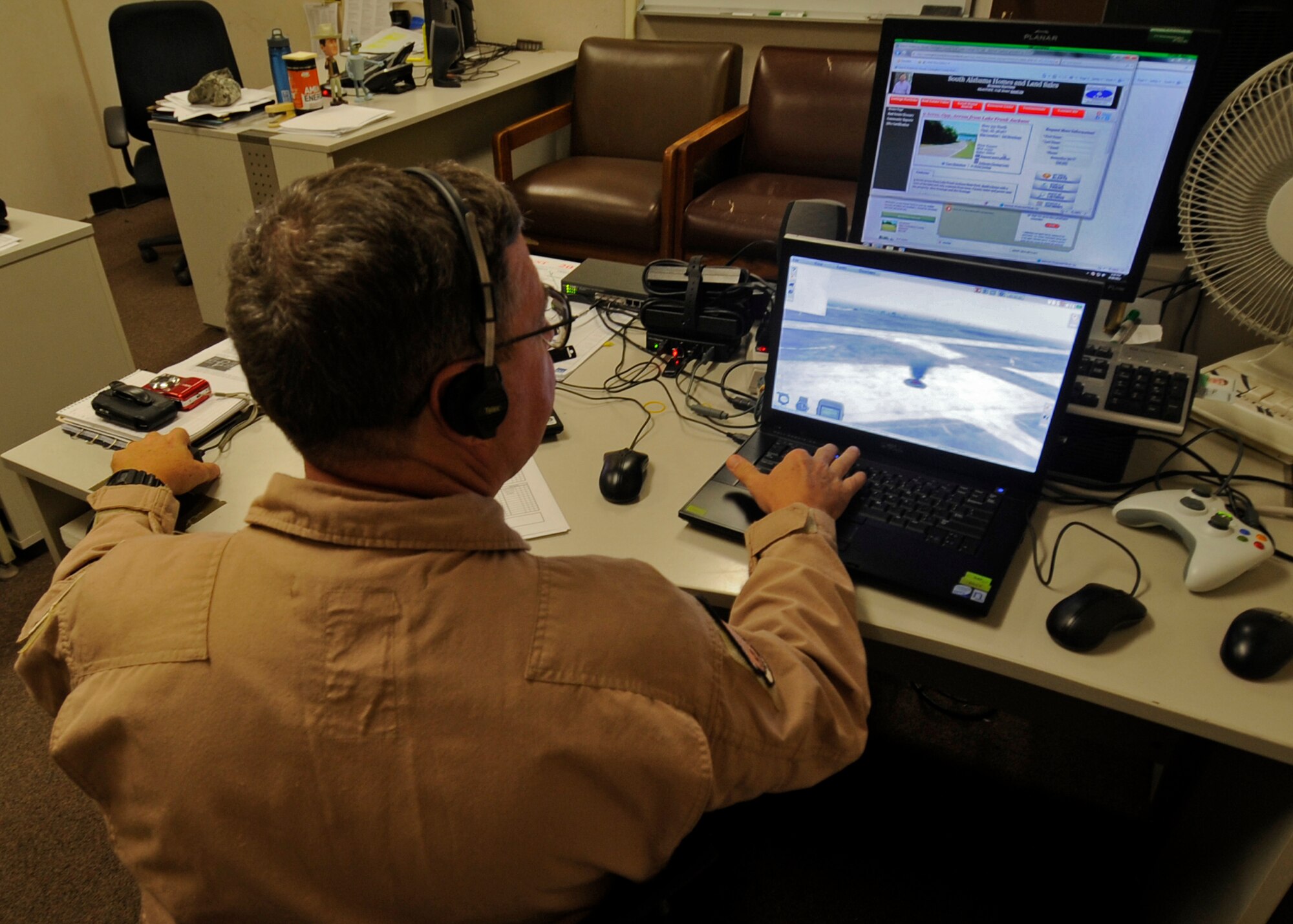 An instructor with Air Force Special Operations Command from Hurlburt Field, Fla., acts as the “gunship” receiving calls for fire support from students in a nearby room Aug. 29, 2012, on Kunsan Air Base, Republic of Korea. The instructor uses multiple programs designed to train service members on how to make calls for fire from the AC-130H Spectre gunship, operated by the U.S. Air Force. (U.S. Air Force photo/Senior Airman Jessica Hines)