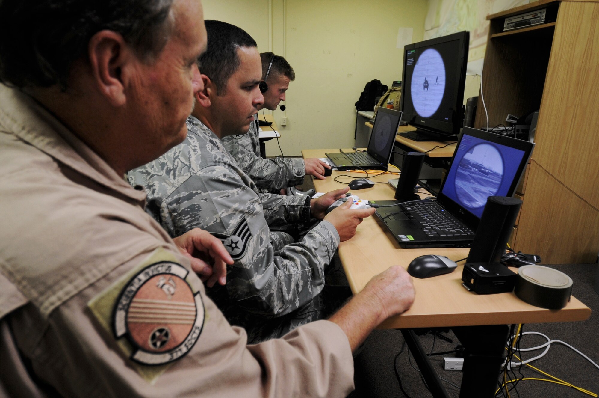 An instructor with Air Force Special Operations Command from Hurlburt Field, Fla., help students of the “call for fire” training, Aug. 29, 2012, on Kunsan Air Base, Republic of Korea. The training uses a computer based program, which creates a virtual setup of a specific area or installation. (U.S. Air Force photo/Senior Airman Jessica Hines)