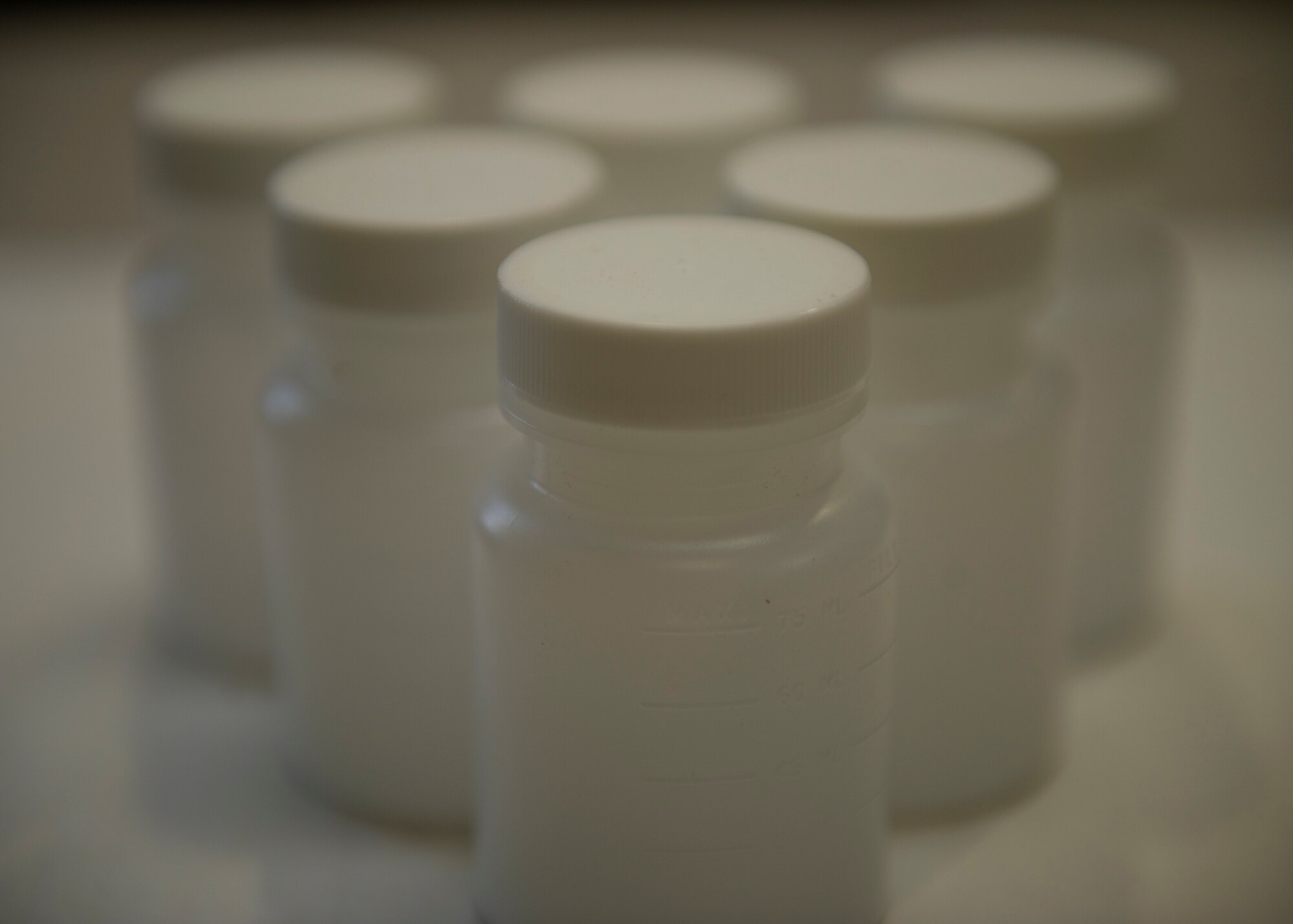 Testing bottles awaiting use are staged on a desk at Holloman Air Force Base, N.M., Sept 5. The testing bottles are not opened until moments before testing and are checked for any contaminants by the Airman being tested and the drug testing observer before official use. The goal of the drug reduction program is to provide education on why doing drugs is bad not only for Airmen’s careers but also for their bodies. The U.S. Air Force has a zero tolerance toward drug use. (U.S. Air Force photo by Senior Airman DeAndre Curtiss/Released)