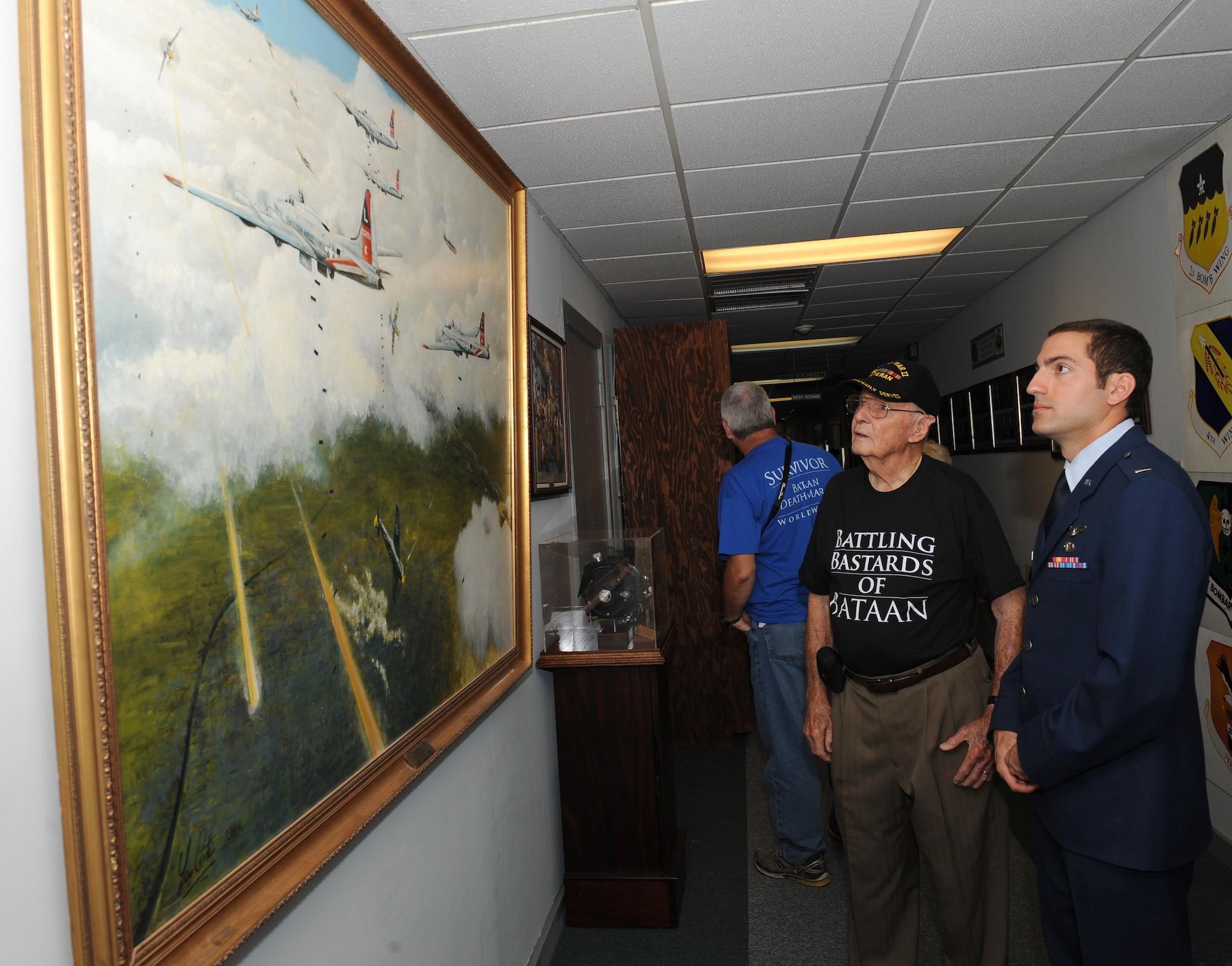 Bataan Death March survivor Erwin Johnson views a painting with his escort 1st Lt. Anthony Mascaro, 11th Bomb Squadron, at the 8th Air Force Museum on Barksdale Air Force Base, La., Sept. 4. Five Bataan Death March survivors were honored by Barksdale leadership, given a tour of the museum and received medals for their sacrifice. (U.S. Air Force photo/Airman 1st Class Benjamin Gonsier)(RELEASED)