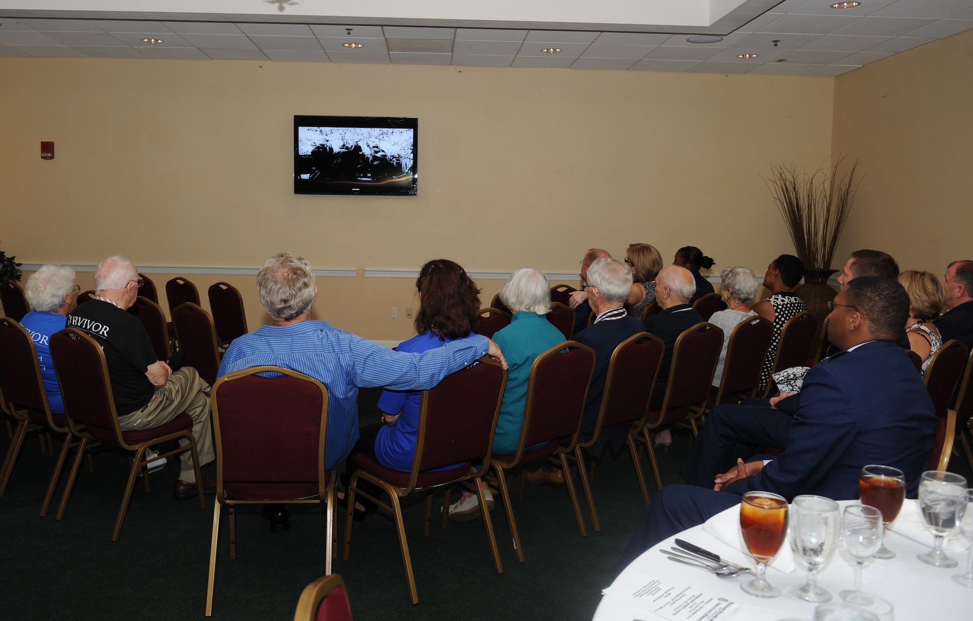 Bataan Death March survivors, their family members and Barksdale Air Force Base, La., leadership watch a film telling the story of the Bataan Death March at Boomtown Casino, Bossier City, La., Sept. 3. Five former prisoners of war were honored during a dinner event where they received medals on behalf of the Philippines. (U.S. Air Force photo/Airman 1st Class Benjamin Gonsier)(RELEASED)
