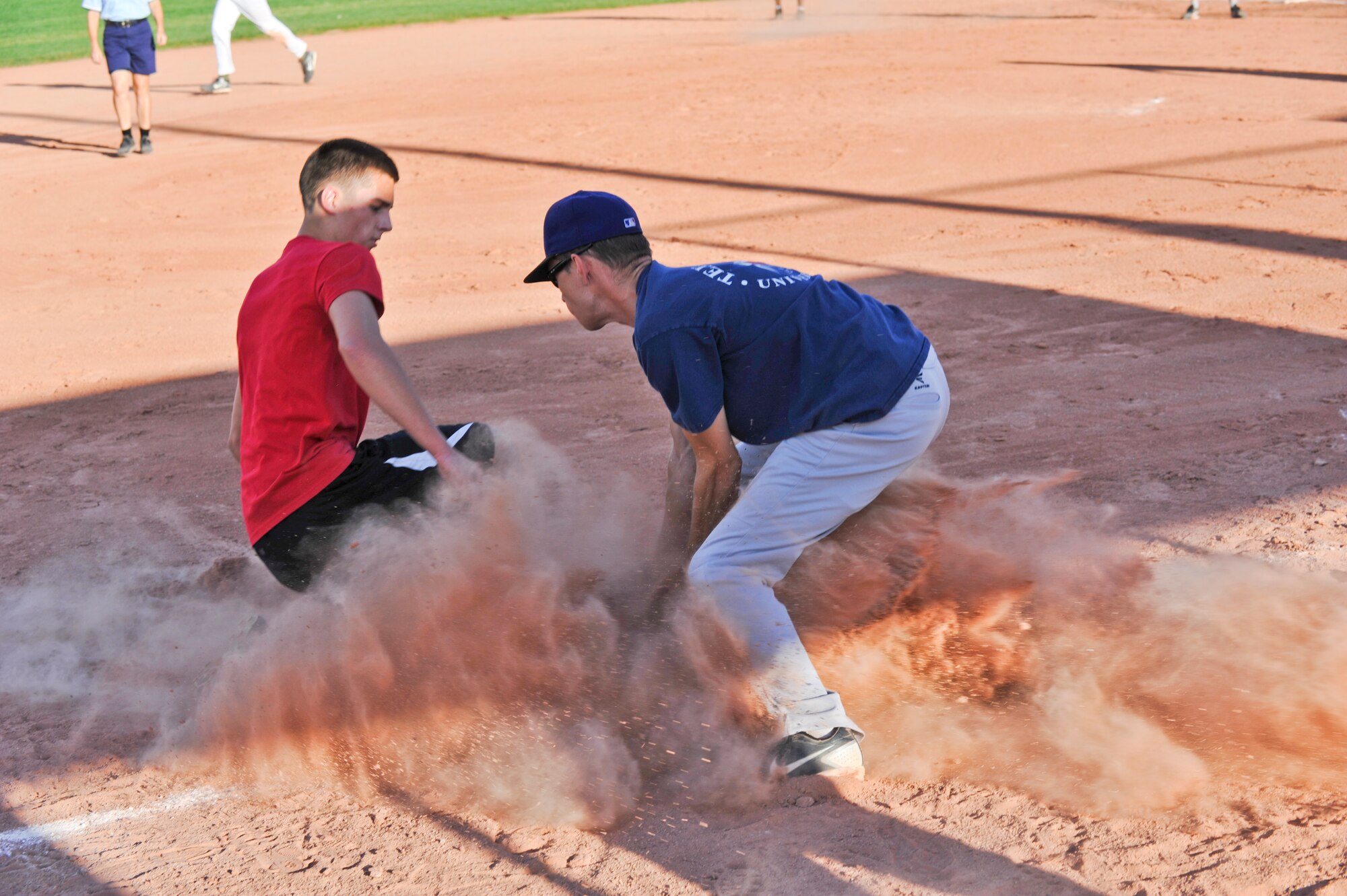 BUCKLEY AIR FORCE BASE, Colo. – Wade Bishop, left, member of SBIR of the 2nd Space Warning Squadron slides into third base safely as Corey Dorsey of the 566th Intelligence Squadron attempts the tag during a Buckley Intramural Softball Championship game Sept. 4, 2012. SBIRS, , won back-to-back games against the 566 IS making them the 2012 intramural softball base champions. (U.S. Air Force photo by Senior Airman Christopher Gross)
	
