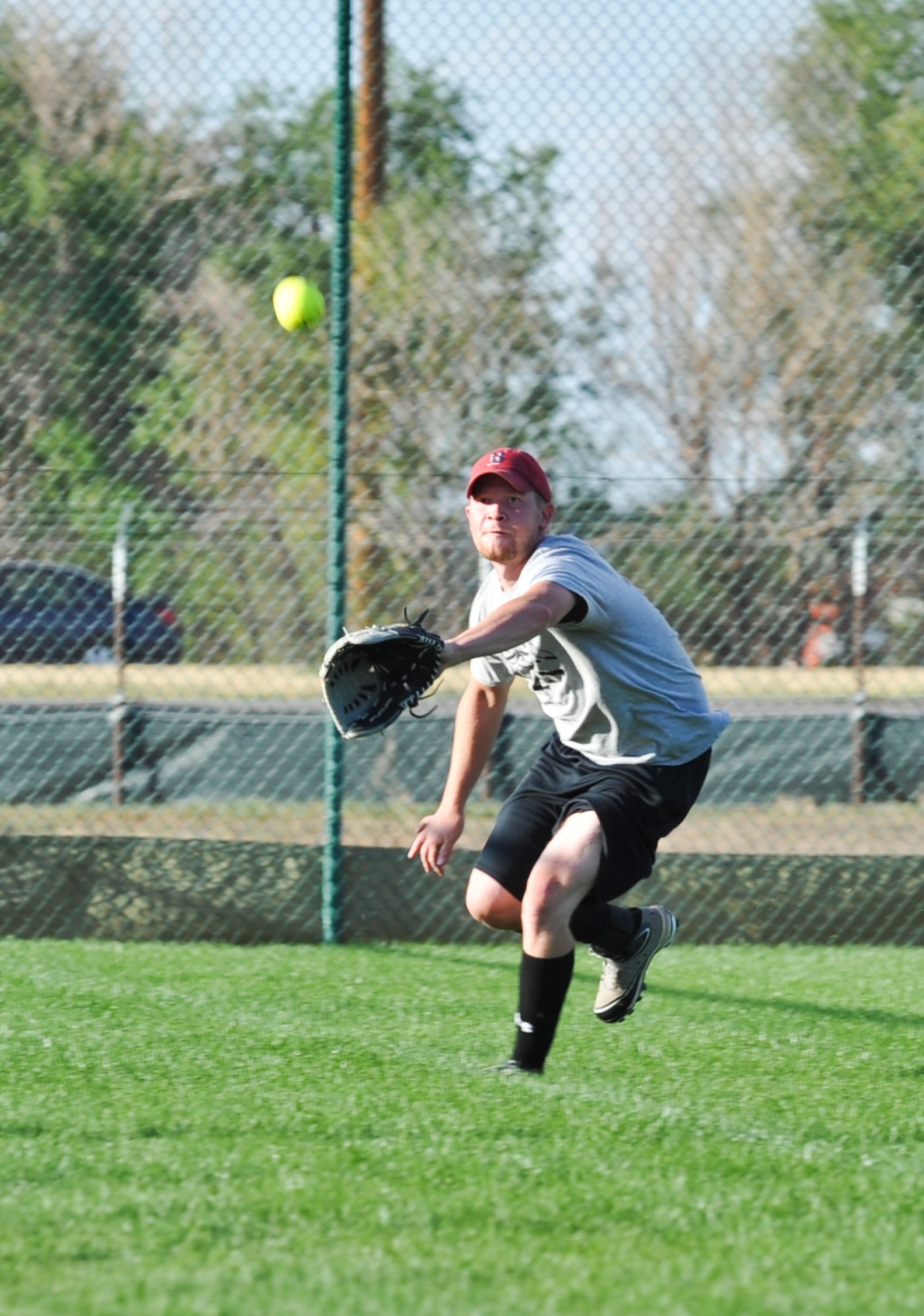 BUCKLEY AIR FORCE BASE, Colo. – Brandon Burnett, 566th Intelligence Squadron left fielder, goes for the catch during a Buckley Intramural Softball Championship game Sept. 4, 2012. The 566th IS lost back-to-back games to SBIRS of the 2nd Space Warning Squadron. (U.S. Air Force photo by Senior Airman Christopher Gross)
