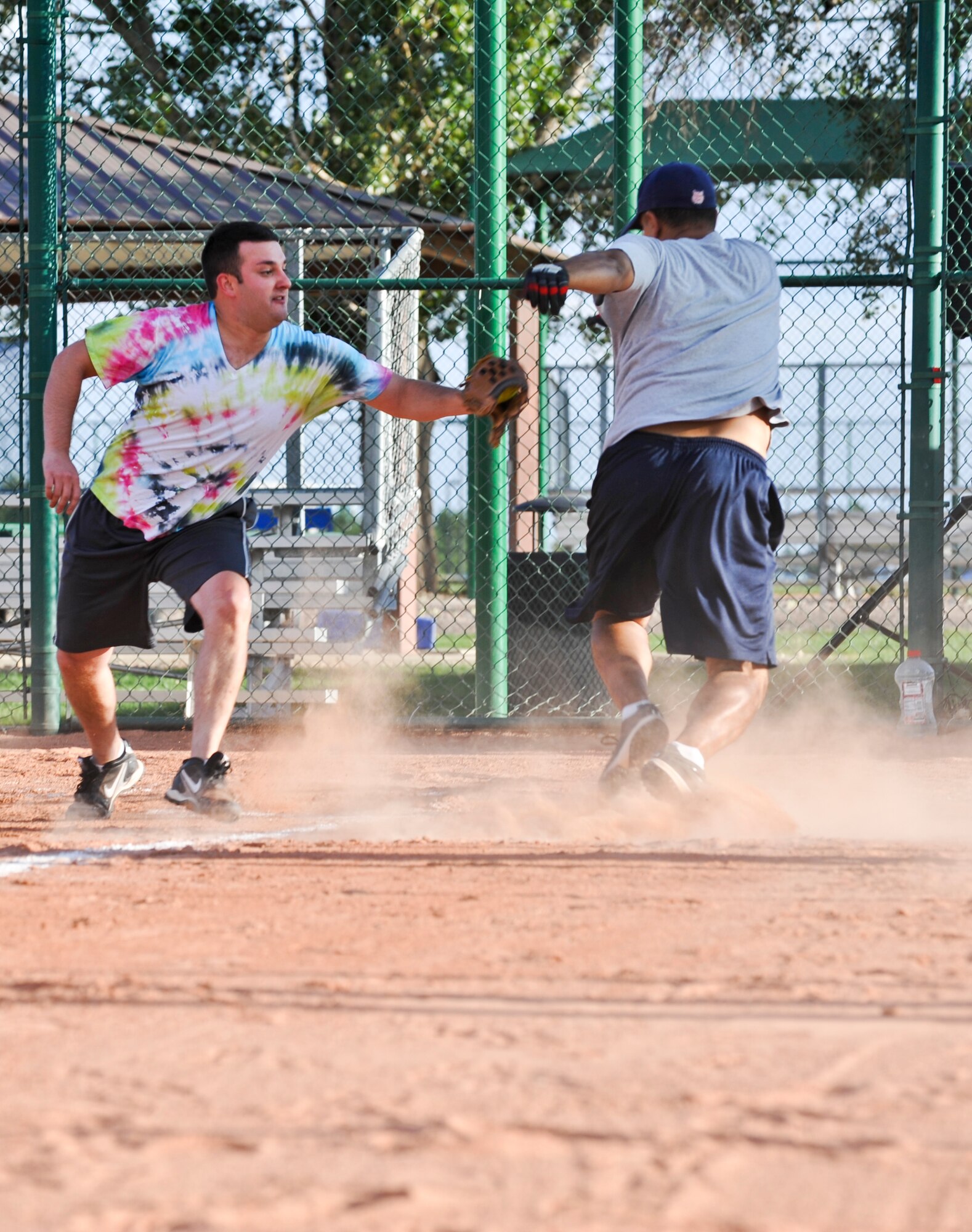 BUCKLEY AIR FORCE BASE, Colo. – Thomas Singleton, 566th Intelligence Squadron catcher, attempts to tag out a runner from the SBIRS of the 2nd Space Warning Squadron, during a Buckley Intramural Softball Championship game Sept. 4, 2012. The 566th IS lost back-to-back games to SBIRS after the 566 IS snuck into the playoffs and beat the top three team placing them in the championship series. (U.S. Air Force photo by Senior Airman Christopher Gross)