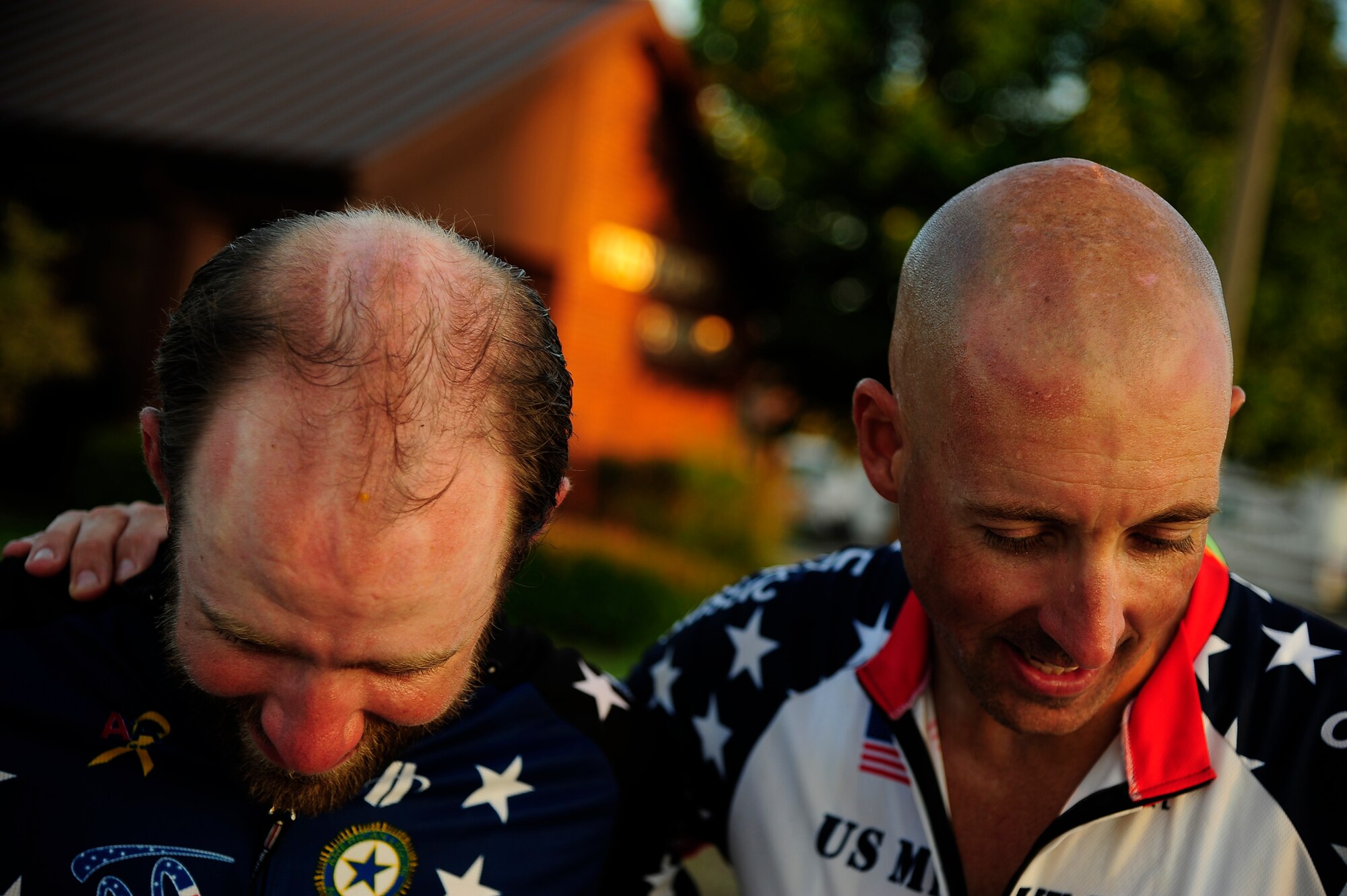 Ryan Creel, a medically retired Army Staff Sgt., and Master Sgt. Andrew Chocha, show off unique sun burns after wearing a bicycle helmet during a 93-miler ride from Kansas City to Whiteman Air Force Base, Mo., Sept. 4. Creel is an official rider for the Long Road Home Project and Chocha is an active duty Air Force member who volunteered to ride for the day during his temporarily deployment from Barksdale Air Force Base.  The Long Road Home Project consists of five prior service members riding 4,200 miles across the country in hopes of bringing awareness to the fact that hundreds of thousands of service people often face difficulty returning home. (U.S. Air Force photo/Senior Airman Cody H. Ramirez)


