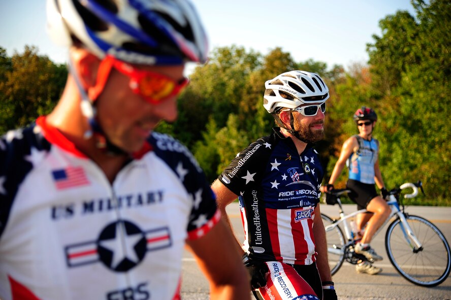 Master Sgt. Andrew Chocha, and Ryan Creel and Marie Tracy, both official riders for the Long Road Home Project, rally outside Whiteman Air Force Base, Mo., Sept. 4. Chocha was a volunteer rider on temporary duty orders from Barskdale Air Force Base. The Long Road Home Project consists of five prior service members riding 4,200 miles across the country in hopes of bringing awareness to the fact that hundreds of thousands of service people often face difficulty returning home. (U.S. Air Force photo/Senior Airman Cody H. Ramirez)