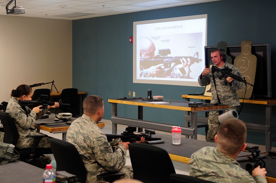 U.S. Air Force Staff Sgt. Austin Adams, 20th Security Forces Squadron combat arms instructor, teaches the ?steady position? of an M-4 rifle to members of the 20th Civil Engineer Squadron for their annual weapons qualification, Shaw Air Force Base, S.C., Sep. 5, 2012. The class consists of three hours of training, which consists of different firing positions and operation and maintenance of the rifle, and five hours for practice firing and qualifying. (U.S. Air Force photo by Airman 1st Class Hunter Brady/Released)