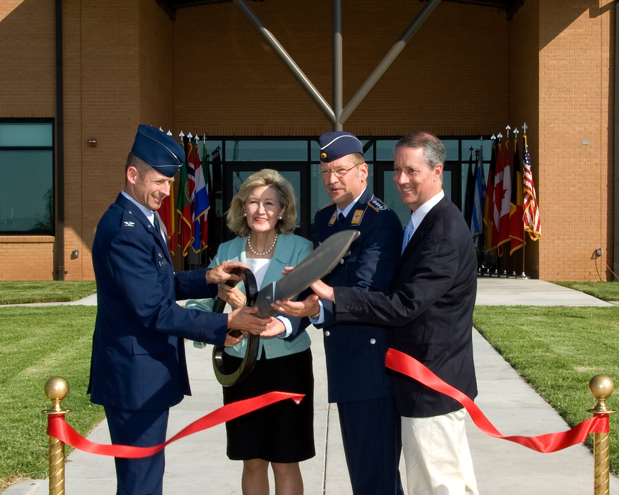 Left to right: The 80th Flying Training Wing Commander Col. Dieter Bareihs, U.S. Senator Kay Bailey Hutchison, 80th Operations Group Commander Eberhard von Wintzingerode-Knorr and U.S. Congressman Mac Thornberry cut the ribbon during an opening ceremony for the new 80th Operations Group Facility at Sheppard Air Force Base on Sep. 5, 2012. (U.S. Air Force photo Frank H. Carter)