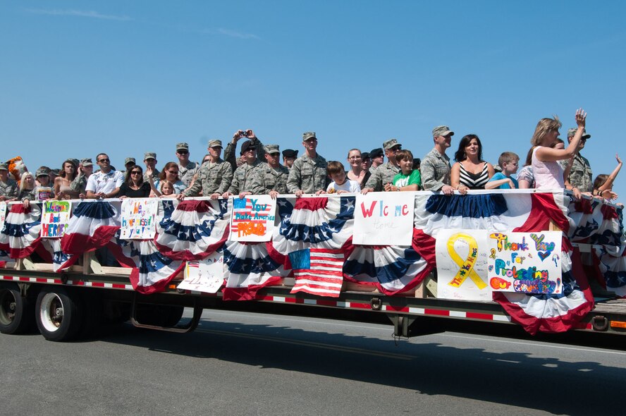 HANSCOM AIR FORCE BASE, Mass. – Airmen and their families wave to the crowd during the parade before Heroes Homecoming Aug. 30. The parade also included Medal of Honor recipients, area professional sports team alumni, duck boats, New England Patriot cheerleaders and more. (U.S. Air Force photo by Rick Berry)