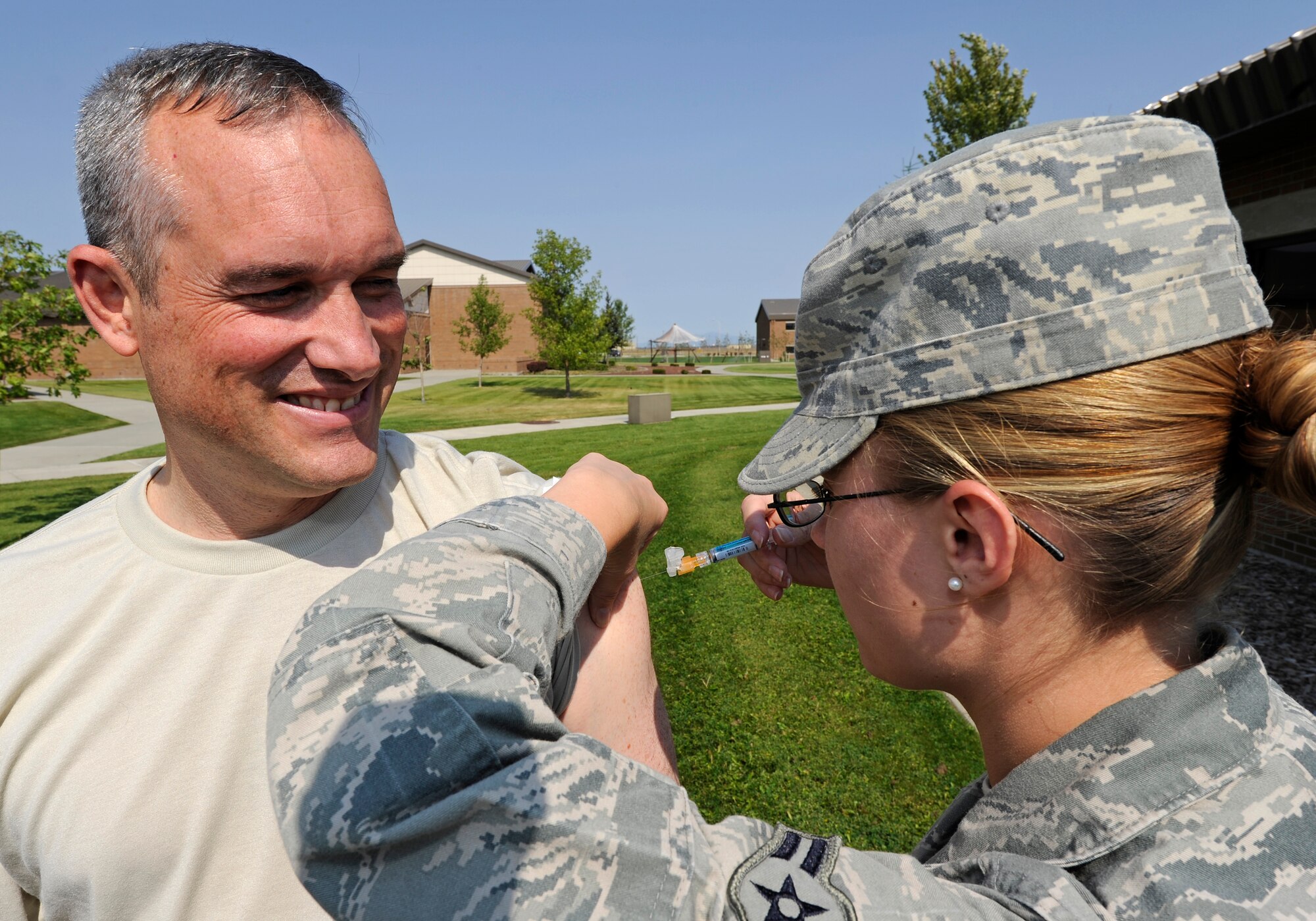 Col. Brian Newberry, 92nd Air Refueling Wing commander, receives his flu shot at the Final Point at Fairchild Air Force Base, Wash., Aug. 31, 2012. The flu vaccine can be injected in the arm or administered through the nose and is now available for Active Duty members and their dependants. (U.S. Air Force photo by Airman 1st Class Ryan Zeski)