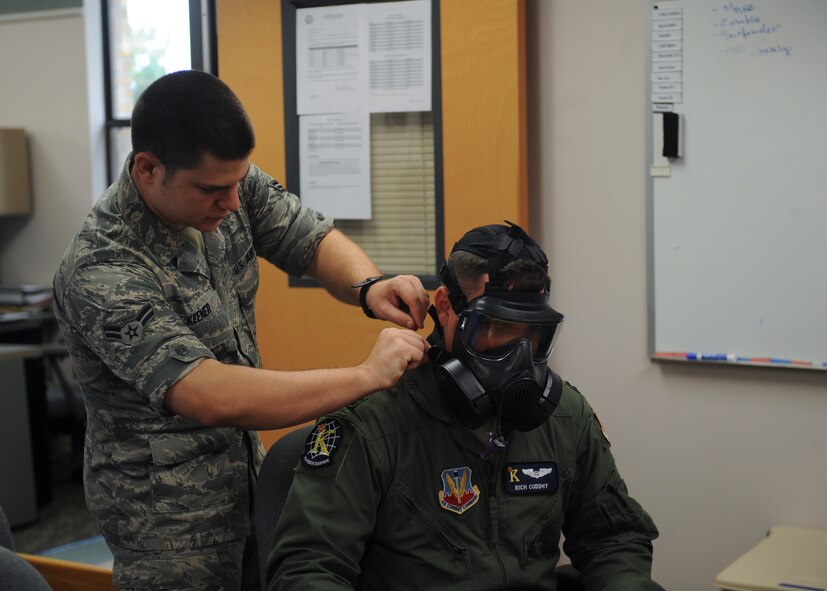 U.S. Air Force Airman 1st Class Andrew Keener, 23d Aerospace Medicine Squadron bioenvironmental engineer, adjusts a gas mask on Capt. Richard Cuddhy, 71st Rescue Squadron HC-130P Combat King navigator, during a fit test at Moody Air Force Base, Ga., Aug. 30, 2012. The 23d AMDS not only does fit tests, but also water samples, noise assessments, air sampling and health risk assessments. (U.S Air Force photo by Airman 1st Class Olivia Dominique/Released)