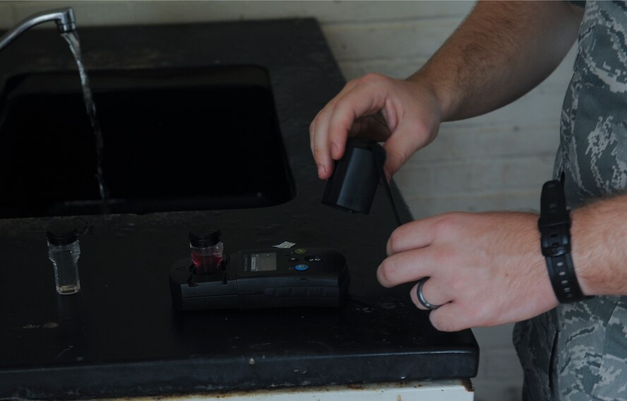 U.S. Air Force Airman 1st Class Andrew Keener, 23d Aerospace Medicine Squadron bioenvironmental engineer, uses a colorimeter while sampling water at Moody Air Force Base, Ga., Aug. 30, 2012. Colorimeters are used to test the pH level and chlorine in water samples. (U.S. Air Force photo by Airman 1st Class Olivia Dominique/Released)