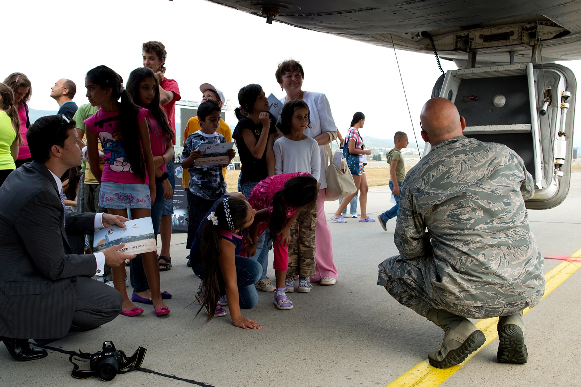 Slovakian school students wait for their turn to climb up inside the cockpit of a 93rd Bomb Squadron B-52H Stratofortress on Aug. 31, 2012, Sliac, Slovakia. Many of the students had to walk miles from their villages to be able to take public transportation to Sliac for this special tour. (U.S. Air Force photo by Master Sgt. Greg Steele/Released)
