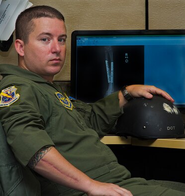 ALTUS AIR FORCE BASE, Okla. – Master Sgt. Lee Adkins, Headquarters Air Mobility Command KC-135 Air Training Squadron Quality Assurance manager, poses with his helmet in front of an X-ray photo of his right arm, July 24, 2012. Adkins was in a near-fatal motorcycle accident Jan. 15, 2012 and recently returned to flying status. Since his accident Adkins keeps his helmet from the wreck on his desk as a conversation starter, to talk about the importance of wearing personal protective equipment. (U.S. Air Force photo by Airman 1st Class Kenneth W. Norman / Released / 97th Air Mobility Wing Public Affairs)