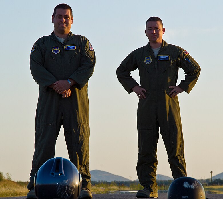 ALTUS AIR FORCE BASE, Okla. – Maj. Adam Travis, 97th Air Mobility Wing flight safety officer, and Master Sgt. Lee Adkins, Headquarters Air Mobility Command KC-135 Air Training Squadron Quality Assurance manager, pose for a photo with their helmets on Tower Road, July 20, 2012. Travis and Adkins were involved in a near fatal motorcycle accident Jan. 15, 2012.Their Personal Protective Equipment and Wingmen saved their lives. (U.S. Air Force photo by Airman 1st Class Kenneth W. Norman / Released / 97th Air Mobility Wing Public Affairs)