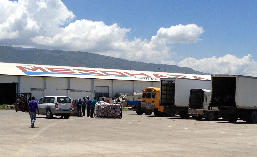 WRIGHT-PATTERSON AIR FORCE BASE, Ohio – Vehicles line up outside a warehouse awaiting pallets of rice and other much needed supplies in Haiti that were unloaded from a 445th Airlift Wing C-17 Globemaster III Aug. 31. The C-17 moved more than 105,000 pounds of cargo to and from Joint Base Charleston, S.C., to Haiti as part of the Denton Program, a program that allows donors to use space available on U.S. military cargo planes to transport humanitarian goods and equipment to countries in need. (Courtesy photo)