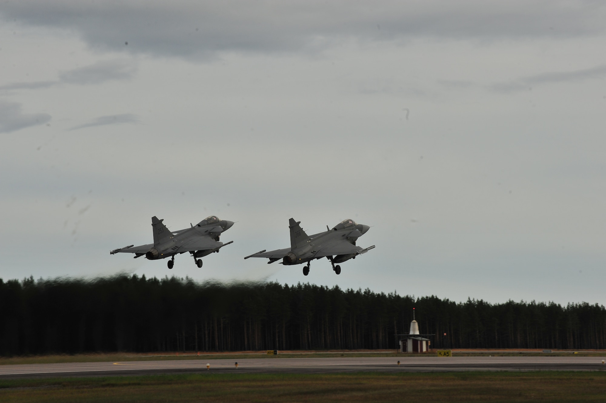 KALLAX AIR BASE, Sweden -- Two Swedish air force JAS 39 Griffin aircraft take off in a two-ship formation here Sept. 3, in support of the Nordic Air Meet 2012. The multinational training exercise brought together more than 50 aircraft from the United States, United Kingdom Denmark, Finland, Switzerland and Sweden to participate in tactical role-playing training missions. The three week exercise enabled the different nations to exchange aerial tactics and capabilities to improve combat power effectiveness in solo and joint environments while building and strengthening international partnerships. (U.S. Air Force Photo by Airman 1st Class Dillon Davis/Released)