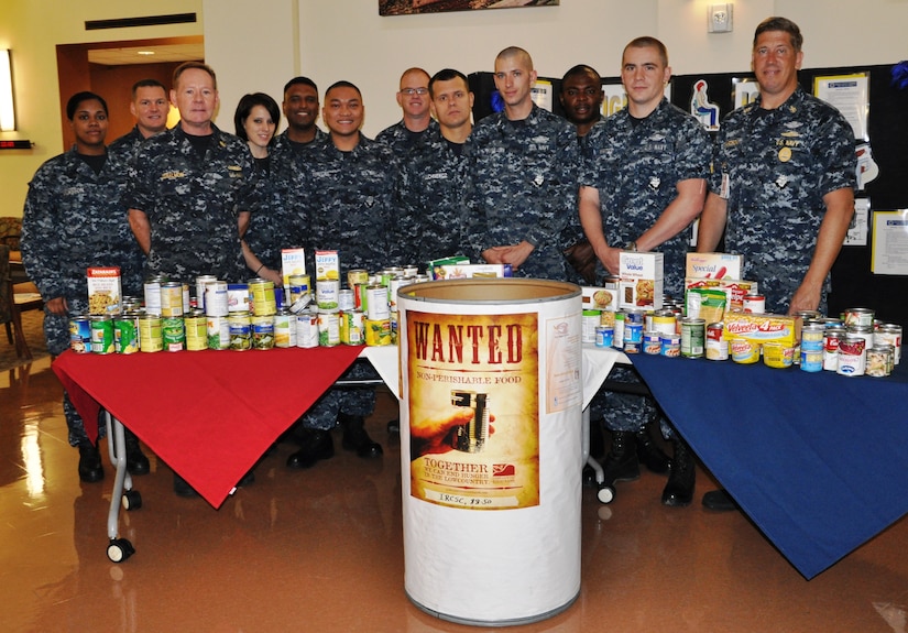Capt. Richard Joralmon, Naval Health Clinic Charleston executive officer (third from left), Joint Base Charleston Chaplain (Lt.) John Quay (second from left) and members of the NHCC Military Medicine department display the food they collected as part of the Feds Feed Families Food Drive. The staff of NHCC holds a contest each year to support the food drive and so far this year, the clinic has donated nearly 600 pounds
of food. Every ounce of food collected goes directly to the tables of Lowcountry families in need. The local efforts of the national food drive are organized by the JB Charleston Chaplains office. (Courtesy photo)
