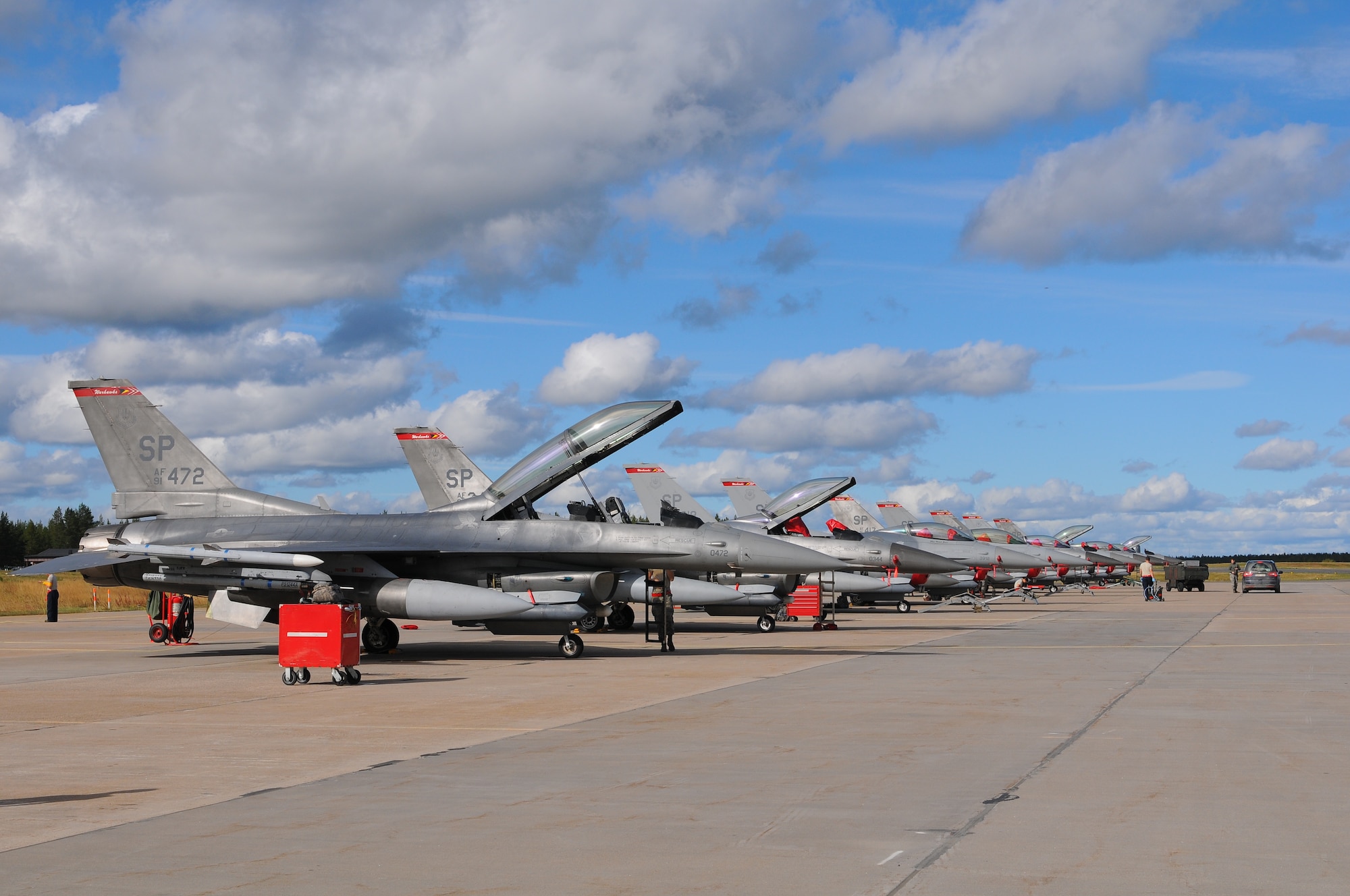 KALLAX AIR BASE, Sweden -- F-16 Fighting Falcon aircraft from the 480th Fighter Squadron sit in a row on the ramp here Sept. 3. The 480th FS from Spangdahlem Air Base is here in  support of the Nordic Air Meet 2012. The multinational training exercise brought together more than 50 aircraft from the United States, United Kingdom, Denmark, Finland, Switzerland and Sweden to participate in tactical role-playing training missions. The three week exercise enabled the different nations to exchange aerial tactics and capabilities to improve combat power effectiveness in solo and joint environments while building and strengthening international partnerships. (U.S. Air Force Photo by Airman 1st Class Dillon Davis/Released)