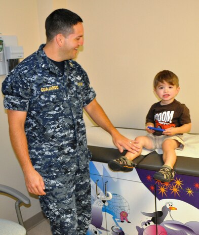 Lt. J.G. David Guajardo waits with his son Liam for a routine appointment at Naval Health Clinic Charleston, Aug. 29, 2012, at Joint Base Charleston – Weapons Station, S.C. Guajrdo’s children received pediatric flu vaccines during their visit. (U.S. Navy photo by Jeff Kelly)