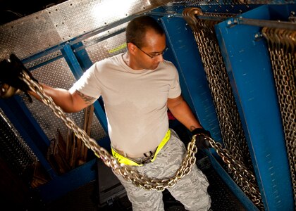 Senior Airman Derik Winston, 437th Aerial Port Squadron air transportation journeyman chooses chains to replace existing chains on a C-17 Globemaster III Aug. 29, 2012, at Joint Base Charleston – Air Base, S.C. The chains secure pallets on the aircraft during flight. (U.S. Air Force photo by Staff Sgt. Katie Gieratz)