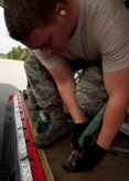 Senior Airman David May, 437th Aerial Port Squadron air transportation journeyman, ties down a pallet on an L100 aircraft Aug. 29, 2012, at Joint Base Charleston – Air Base, S.C. The pallets contained food and medical supplies to assist the U.S. embassy Soto Cano, Honduras. (U.S. Air Force photo by Staff Sgt. Katie Gieratz)