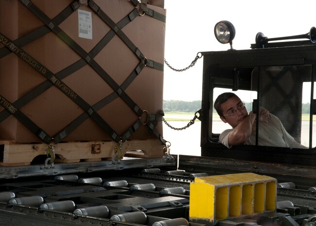 Senior Airman Ivan Fernandez, 437th Aerial Port Squadron air transportation journeyman, ensures the 60k tunner is positioned properly to load an aircraft Aug. 29, 2012, at Joint Base Charleston – Air Base, S.C. The 60k tunner is used to load and unload pallets from aircraft. (U.S. Air Force photo by Staff Sgt. Katie Gieratz)