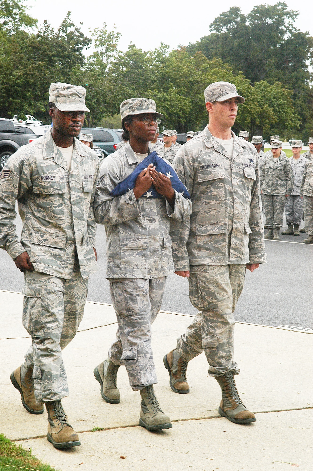 Senior Airman Arthur Burney, 78th Air Base Wing SCSE, Senior Airman Ardella Kelly, 78th ABW MDG, and Senior Airman MacKenzie Thompson, 54th CBCS, retire the flag during retreat Aug. 30.  (U. S. Air Force photo/Sue Sapp)