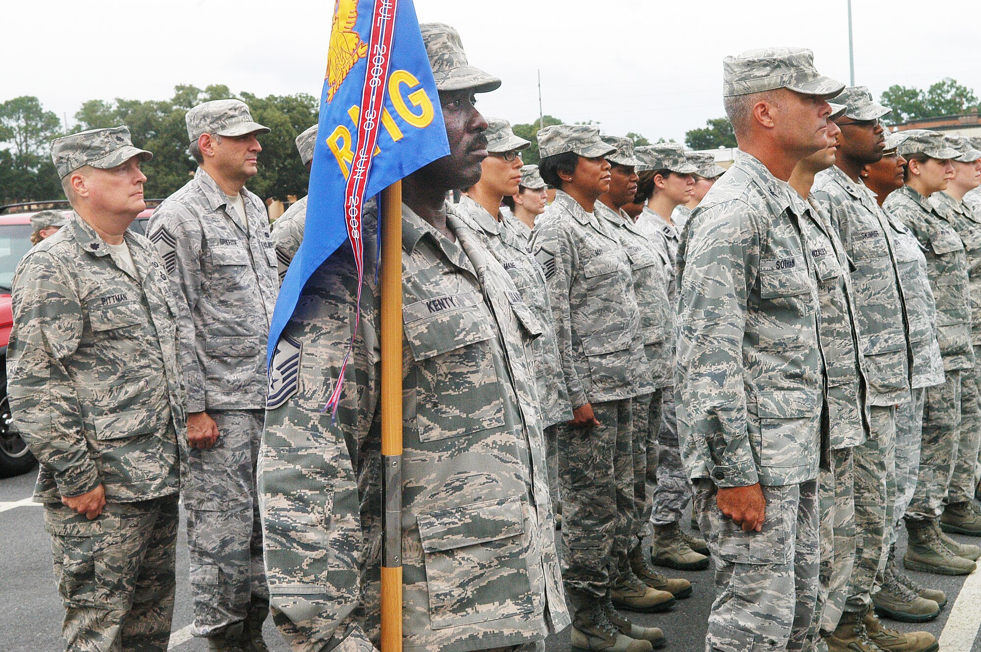Master Sgt. Ike Kenty, Air Force Reserve Command  HQ Readiness Management Group First Sergeant, holds the guidon for the formation during a  retreat ceremony Aug. 30.  (U. S. Air Force photo/Sue Sapp)
