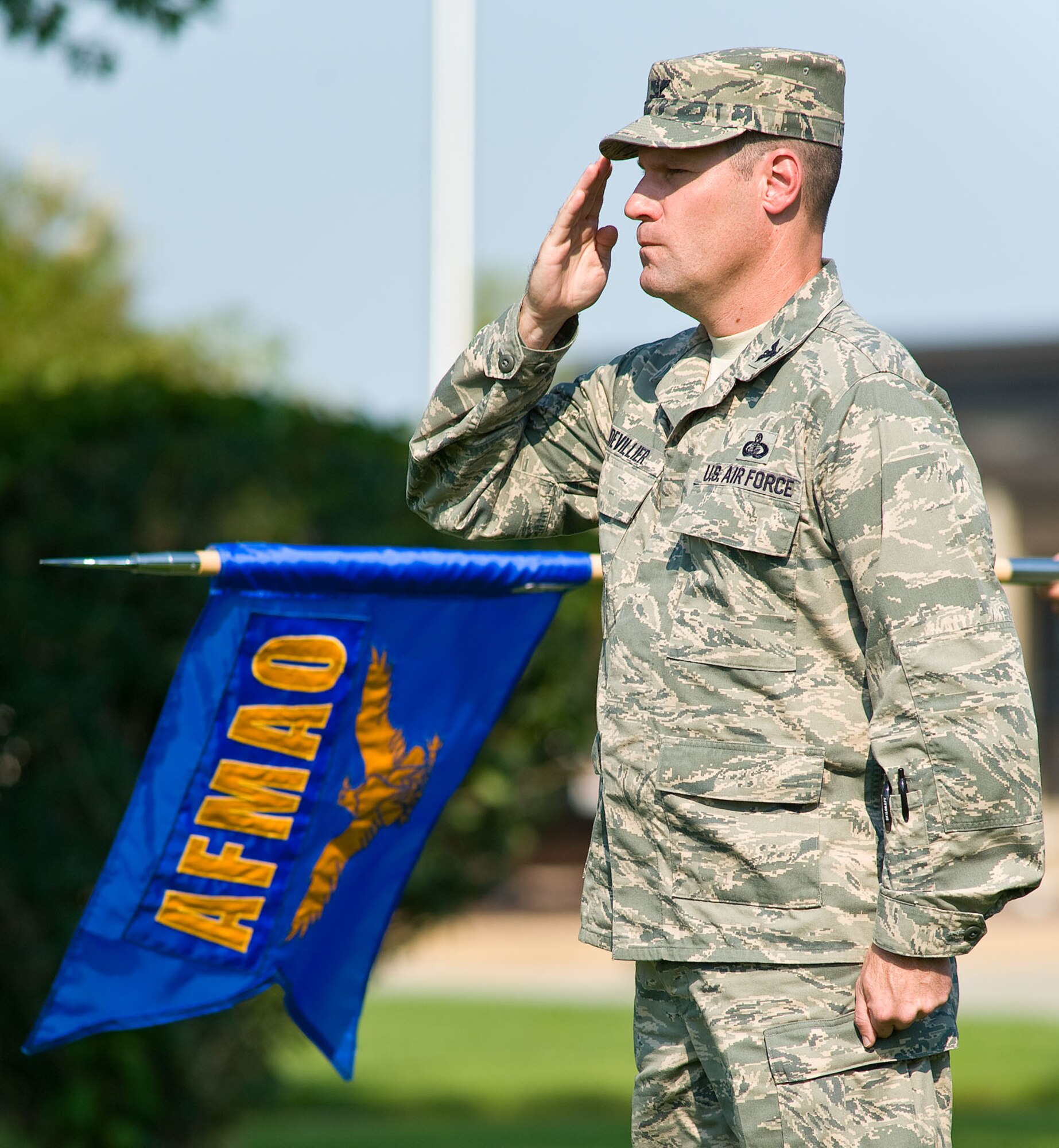 Col. John Devillier, commander of Air Force Mortuary Affairs Operations, salutes during retreat at the base flag pole Aug. 31, 2012, at Dover Air Force Base, Del. (U.S. Air Force photo by Roland Balik)
