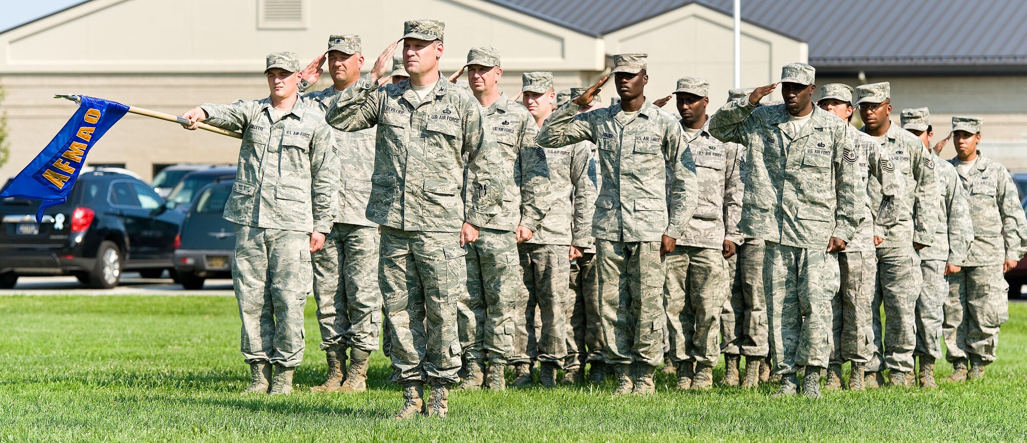Members of Air Force Mortuary Affairs Operations salute during retreat at the base flag pole Aug. 31, 2012, at Dover Air Force Base, Del. (U.S. Air Force photo by Roland Balik)