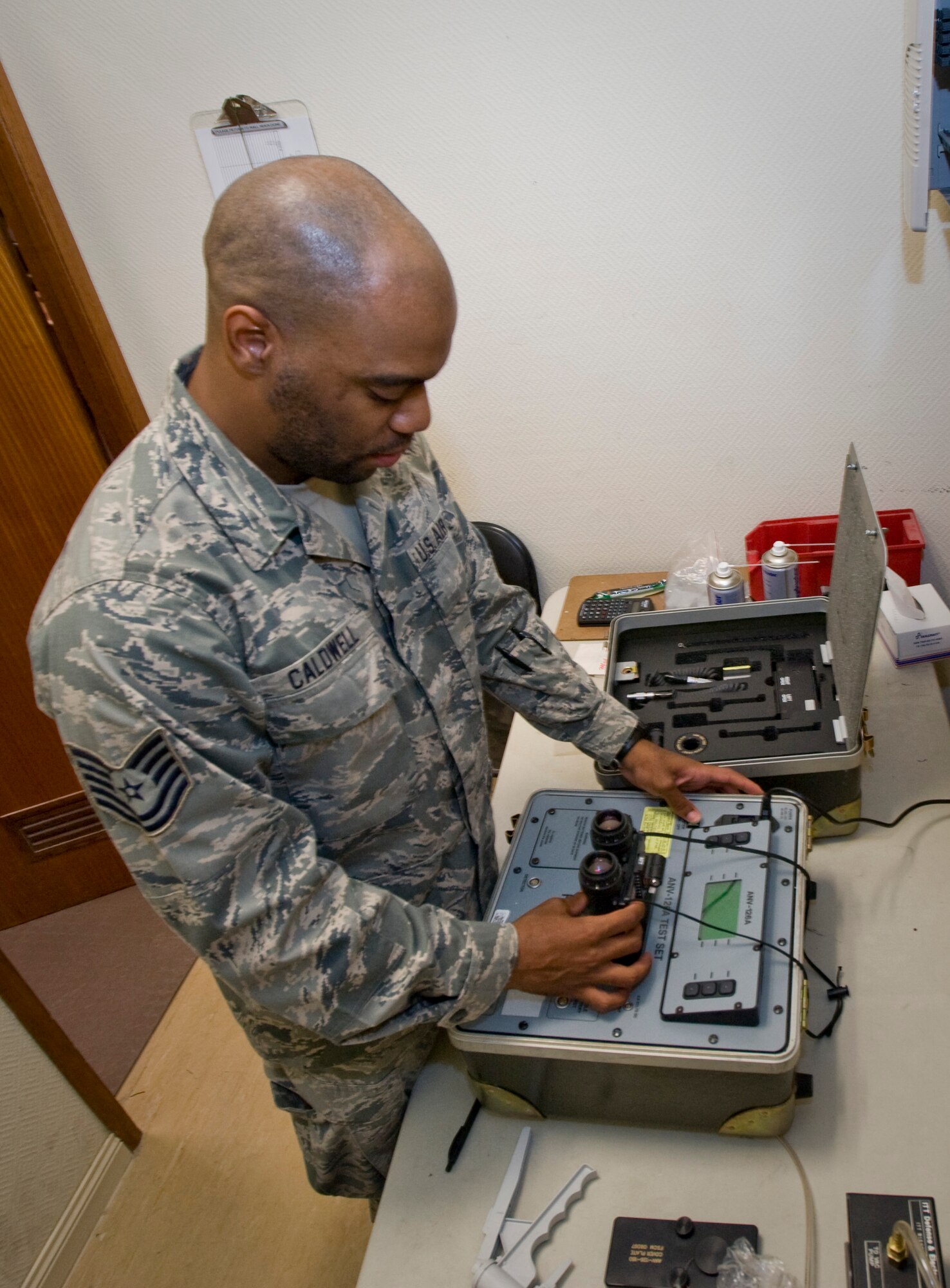 Tech. Sgt. Preston Caldwell, 379th Aircrew Flight Equipment C-130 Hercules technician, prepares night vision goggles to be tested on an ANV-126A Test Set Aug. 21, 2012. Caldwell, and other C-130 technicians, conduct routine inspections on all equipment the crew requires during their mission. He is deployed from Dobbins Air Reserve Base, Ga., and is a native of Florala, Ala. (U.S. Air Force photo by Senior Airman Bryan Swink)