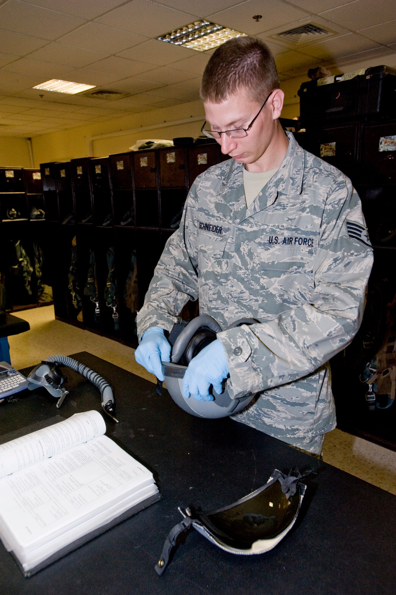 Staff Sgt. Eric Schneider, 379th Aircrew Flight Equipment B-1 Lancer technician, performs a routine inspection on a helmet for a B1 pilot Aug. 21, 2012. Schneider performs pre- and post-flight equipment checks on all equipment the crew requires during their mission. He is deployed from Ellsworth Air Force Base, S.D., and is a native of Brillion, Wis. (U.S. Air Force photo by Senior Airman Bryan Swink)