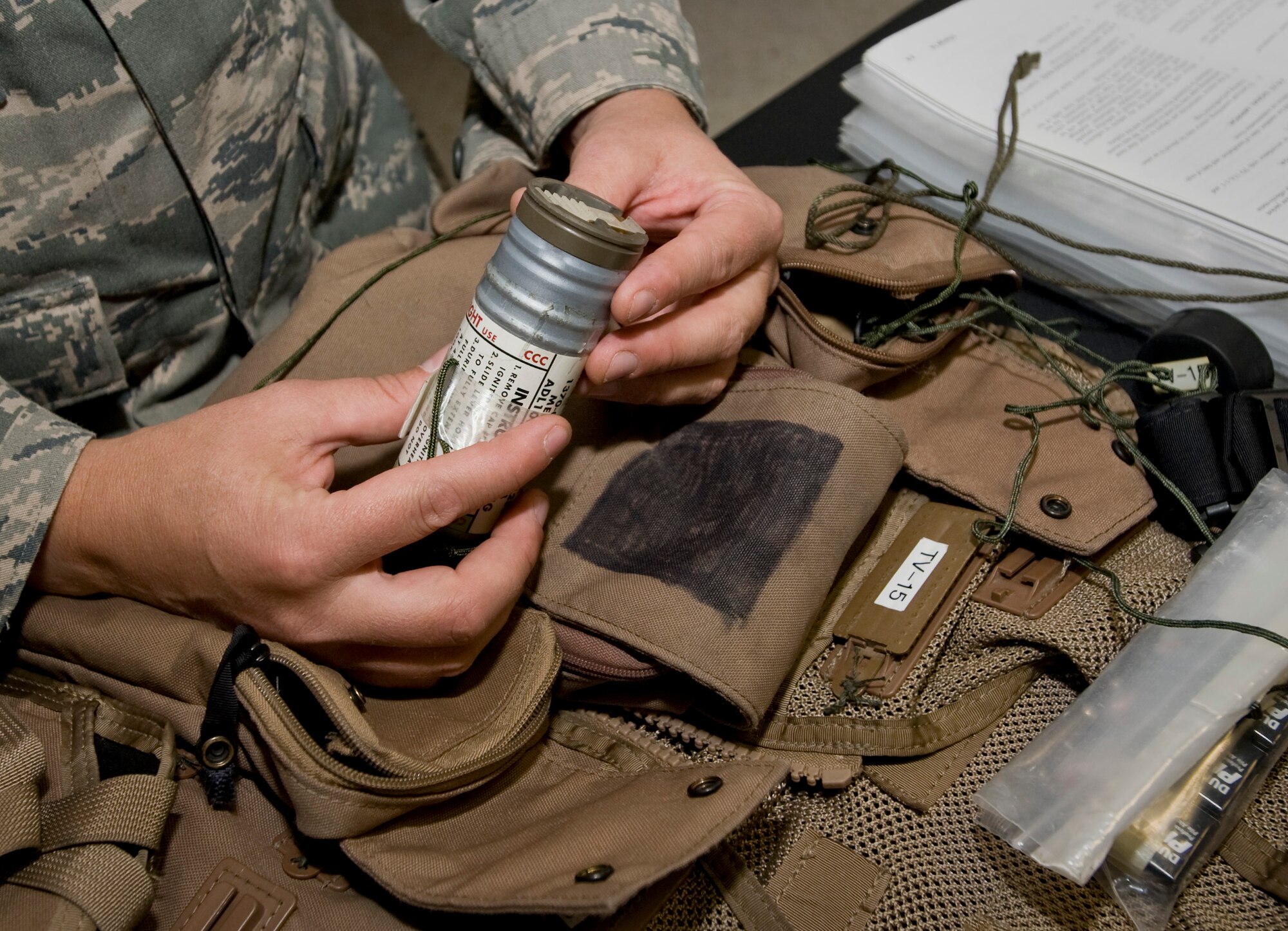 Staff Sgt. Reid Huckle, 379th Aircrew Flight Equipment B-1 Lancer assistant noncommissioned officer in charge, conducts an inspection on the equipment in the survival kit attached to the 38 P life preserver Aug. 21, 2012. Huckle, and the B-1 team, inspect and maintain a variety of equipment to include but not limited to life preservers, parachutes, floatation devices, helmets and oxygen masks, glint tape and infrared glow sticks. Huckle is deployed from Ellsworth Air Force Base, S.D., and is a native of Parkers Prairie, Minn. (U.S. Air Force photo by Senior Airman Bryan Swink)