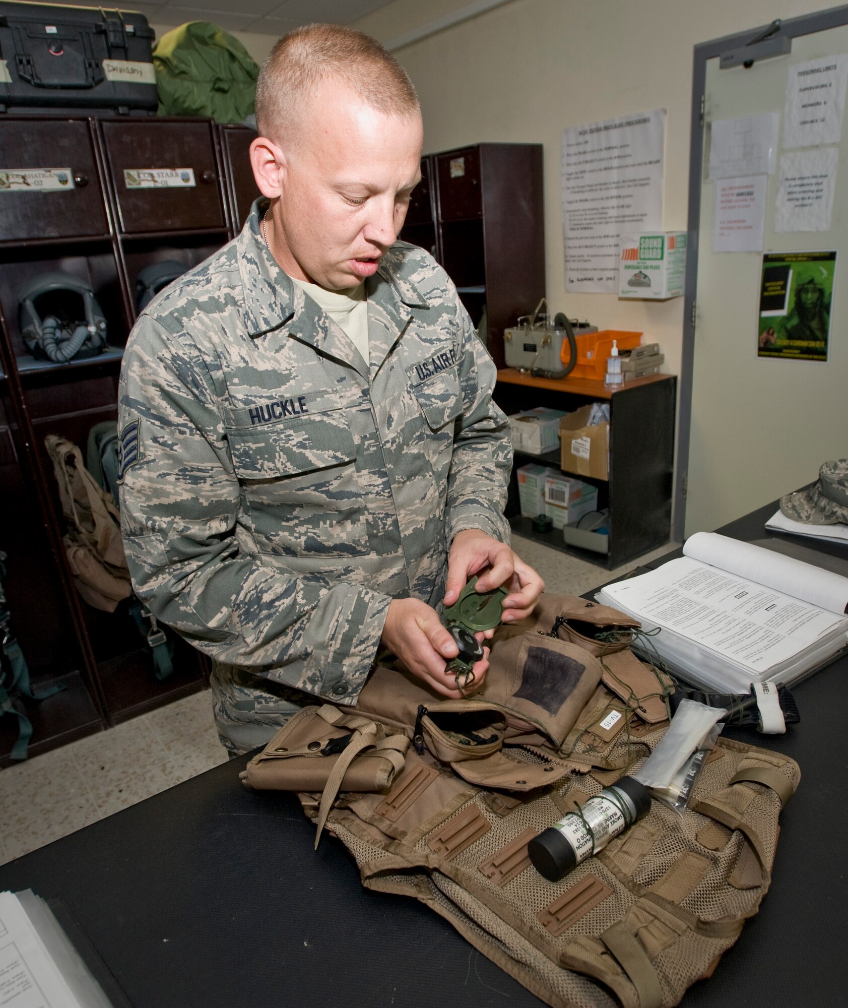 Staff Sgt. Reid Huckle, 379th Aircrew Flight Equipment B-1 Lancer assistant noncommissioned officer in charge, conducts an inspection on the equipment in the survival kit attached to the 38 P life preserver Aug. 21, 2012. Huckle, and the B-1 team, inspect and maintain a variety of equipment to include but not limited to life preservers, parachutes, floatation devices, helmets and oxygen masks, glint tape and infrared glow sticks. Huckle is deployed from Ellsworth Air Force Base, S.D., and is a native of Parkers Prairie, Minn. (U.S. Air Force photo by Senior Airman Bryan Swink)