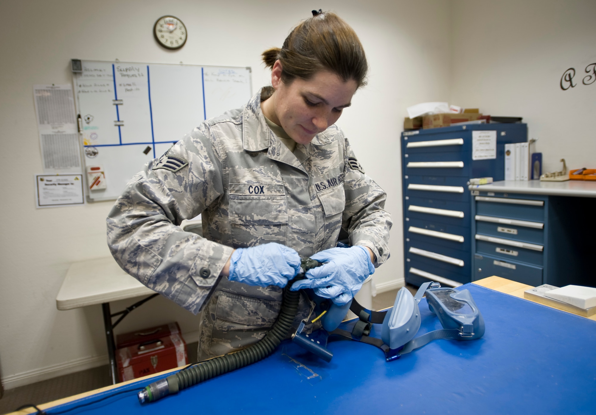 Senior Airman Tracy Cox, 379th Aircrew Flight Equipment KC-135 Stratotanker technician, conducts a full inspection of a Scot 358 quick don mask to ensure there are no rips or tears to the tubing Aug. 21, 2012. Cox performs pre- and post-flight equipment checks on all equipment the crew requires during their mission. She is deployed from Seymour Johnson Air Force Base, N.C., and is a native of Sharpsville, Pa. (U.S. Air Force photo by Senior Airman Bryan Swink)