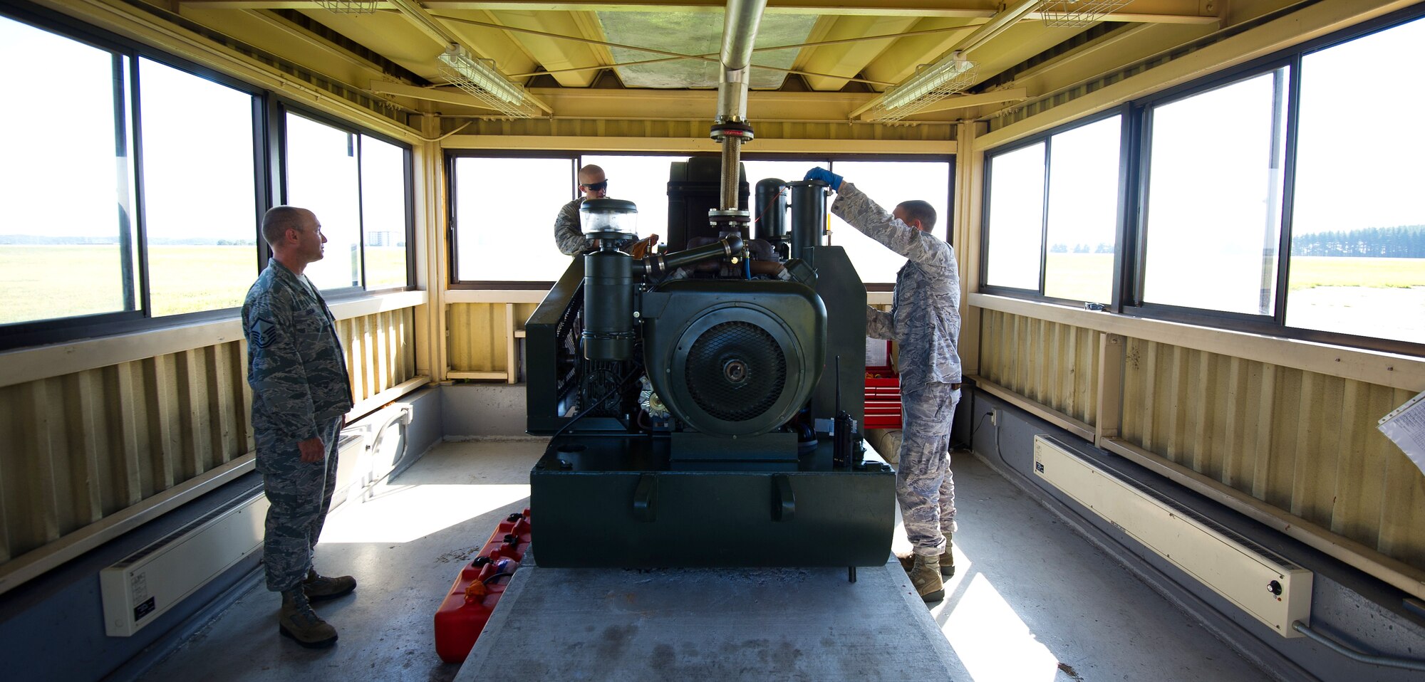 YOKOTA AIR BASE, Japan -- From the left, Master Sgt. Dennis Odom, Airman 1st Class Johnathan Riley and Staff Sgt. Daniel Knowlton, 374th Civil Engineer Squadron electrical power productions technicians, clean and inspect a BAK-12 aircraft arresting system at Yokota Air Base, Japan, on Sept. 5, 2012. Each BAK-12 system holds approximately seven gallons of hydraulic fluid and must be inspected routinely for leaks. (U.S. Air Force photo by Staff Sgt. Chad C. Strohmeyer)